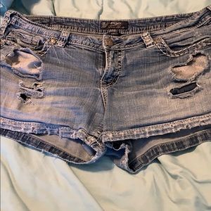 Silver distressed shorts.